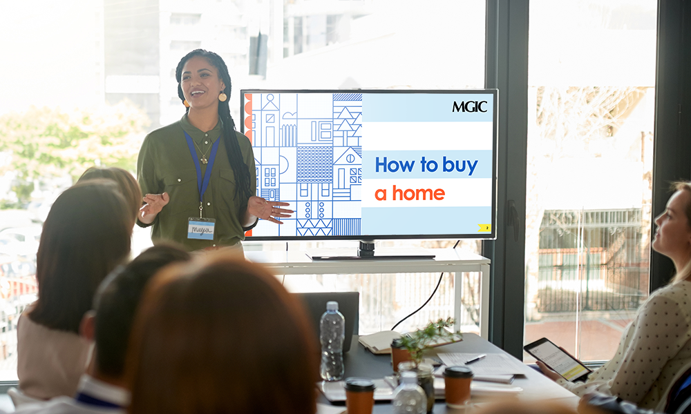 Woman giving homebuyer seminar training to a group of people