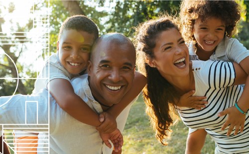 Smiling couple with two young children outdoors