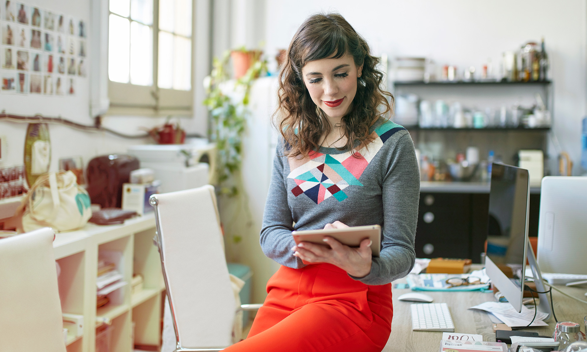 Lady sitting on desk taking notes